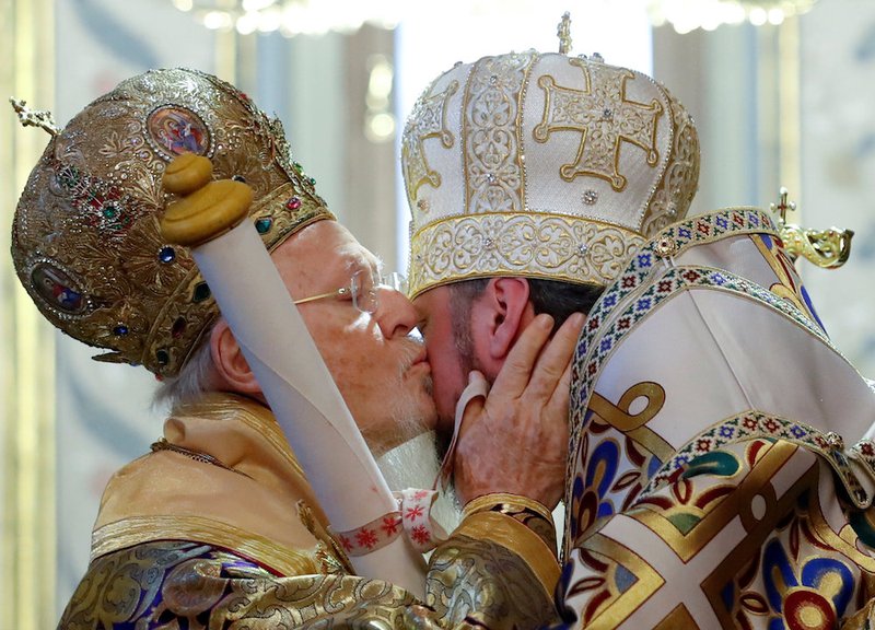 Ecumenical Patriarch Bartholomew of Constantinople kisses Metropolitan Epiphanius