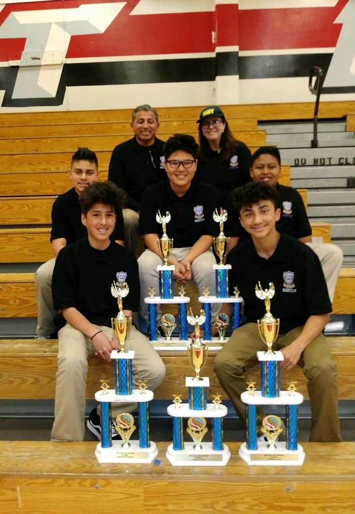 St. Gregory the Great students hold their 5 trophies for winning the overall Middle School Division and placing 1st in the Obstacle Course