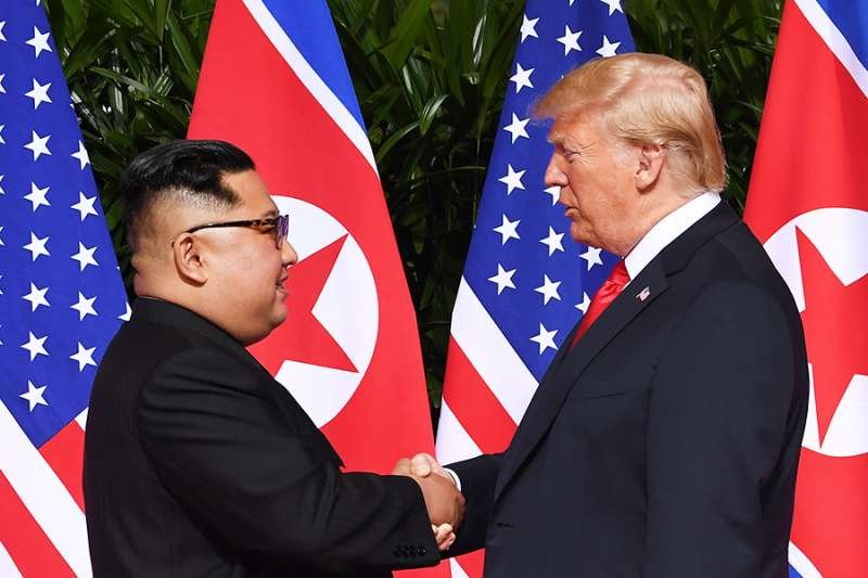 North Korea's leader Kim Jong Un shakes hands with US President Donald Trump at the start of the US-North Korea summit
