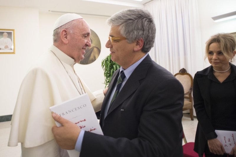 Pope Francis greets Italian journalist Andrea Tornielli during a 2016 meeting with people involved in the publication of "The Name of God Is Mercy