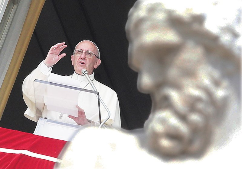 Pope Francis leads the Angelus from the window of his studio overlooking St. Peter’s Square Sept. 24 at the Vatican. (CNS PHOTO/ALESSANDRO BIANCHI