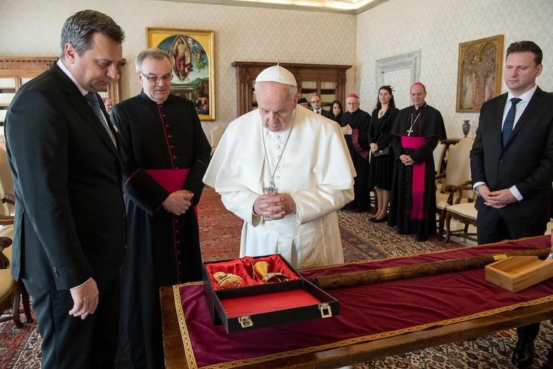 Pope Francis admires gifts given to him March 22