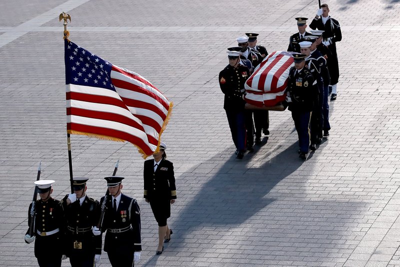 A military honor guard carries the flag-draped casket of former U.S. President George H.W. Bush to lie in state in the rotunda of the U.S. Capitol Dec. 3 in Washington. Bush