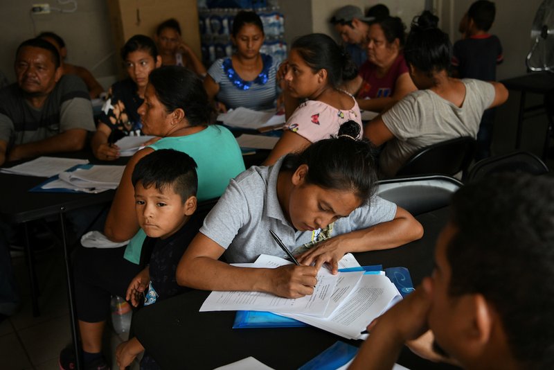 Asylum-seekers sent back to Mexico from the U.S. under Migrant Protection Protocols receive legal advice from attorneys volunteering their time Aug. 24