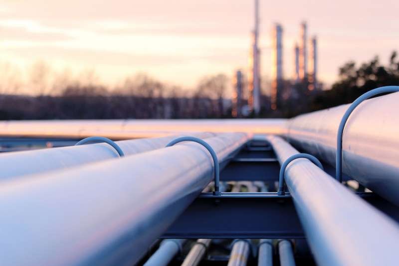 Long pipes in refinery during sunset. Credit: Shutterstock