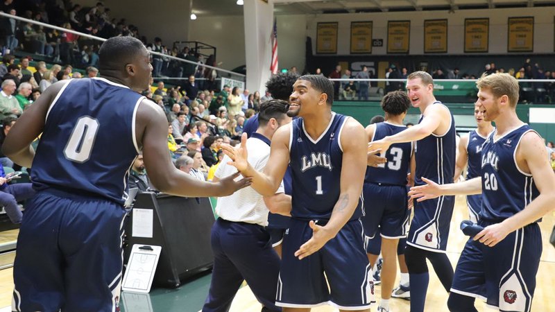 LMU’s men’s basketball team celebrates its 20th win of the year March 2