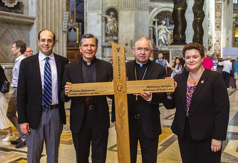 Leaders in ministry to U.S. Hispanic Catholics stand in St. Peter’s Basilica at the Vatican in 2016 with the Encuentro cross. They are from left: Alejandro Aguilera-Titus