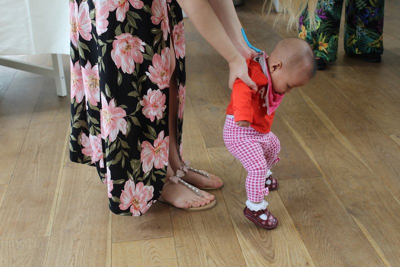 A woman holds a child at Caritas Bakhita House in London. Owned by London's Catholic Archdiocese of Westminster and managed by Caritas Westminster