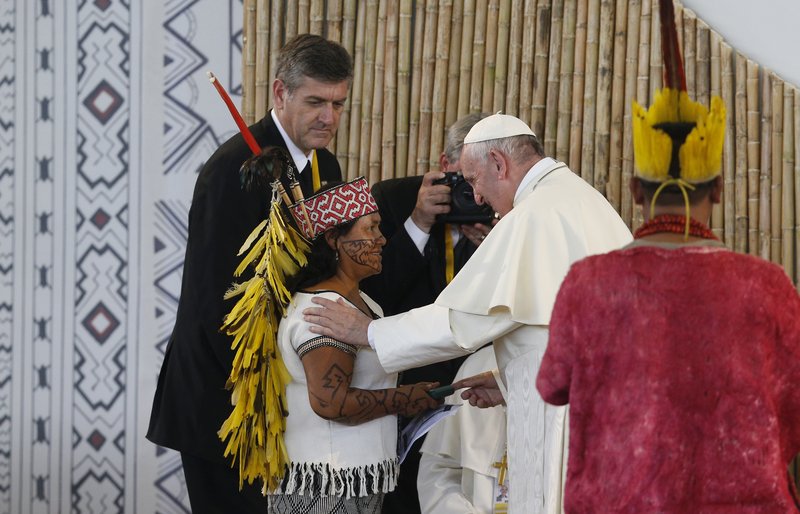 Pope Francis greets a woman during a meeting with people of the Amazon in Puerto Maldonado