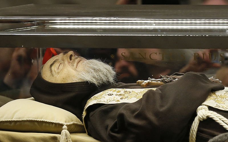 The body of St. Padre Pio is carried in procession in St. Peter’s Basilica at the Vatican Feb. 5