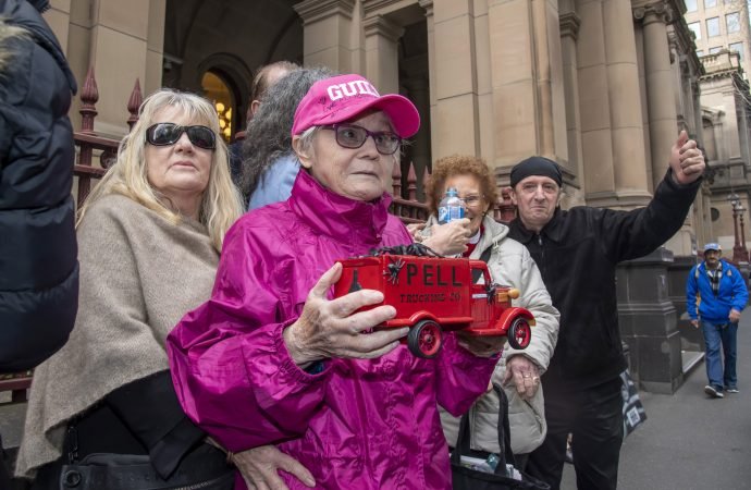 Supporters of abuse victims stand outside the Supreme Court in Melbourne
