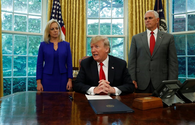 President Donald Trump is seen with with Secretary of Homeland Security Kirstjen Nielsen and Vice President Mike Pence at the White House June 20 prior to signing an executive order to halt the separation of families. (CNS photo/Leah Millis