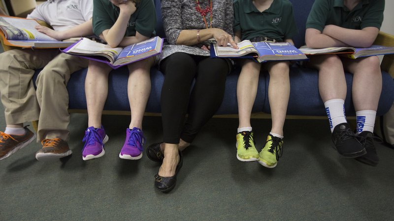A teacher at Holy Name of Jesus Catholic School in Henderson, Ky., helps third-grade students with a reading lesson in 2019. (CNS photo/Tyler Orsburn)