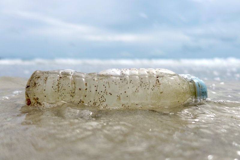 A plastic bottle washed up by the sea is seen in early June along a beach on the island of Ko Samet