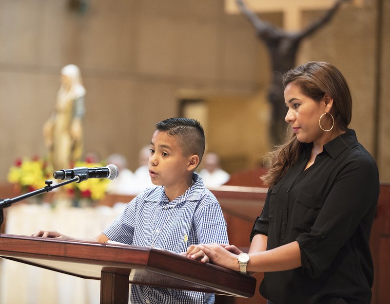 Eleven-year-old Adán shares his experience before the start of the June 24 Mass for All Immigrants