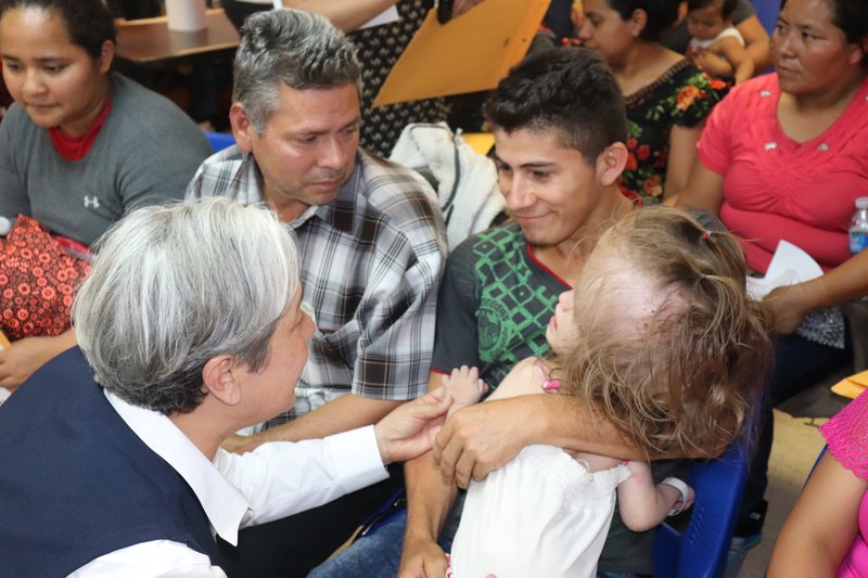Sister Norma Pimentel M.J. welcomes a migrant child with a brain tumor to the Catholic Charities Respite Center in McAllen