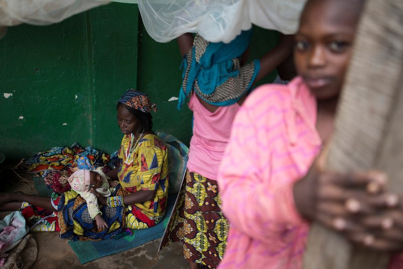 A woman holds her baby at a shelter for displaced people in Bangui