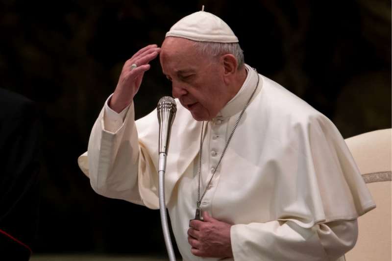 Pope Francis prays at his Wednesday general audience Feb. 13