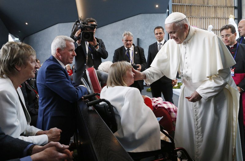 Pope Francis greet a local parishioner as he visits the Chapel of the Apparitions at the Knock Shrine in Knock