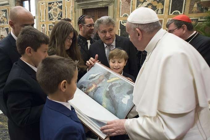 Pope Francis receives a new annotated edition of the Torah at the Vatican Feb. 23
