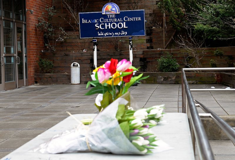 People leave flowers at the Islamic Cultural Center of New York in New York City March 15
