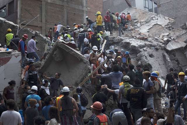 Rescuers work in the rubble after a magnitude 7.1 earthquake struck on Sept. 19