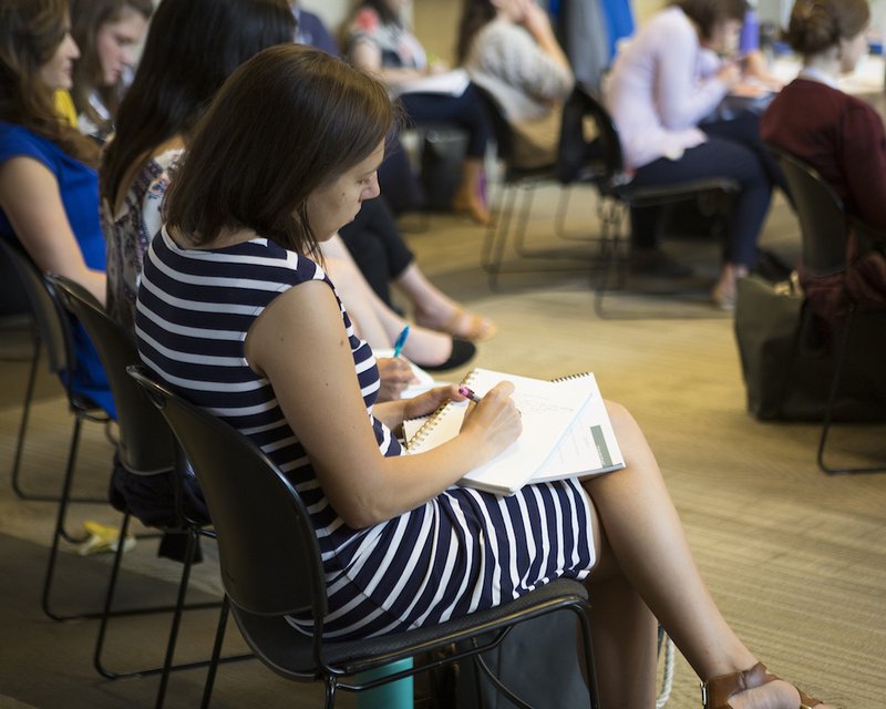 Attendees take notes during a June 13