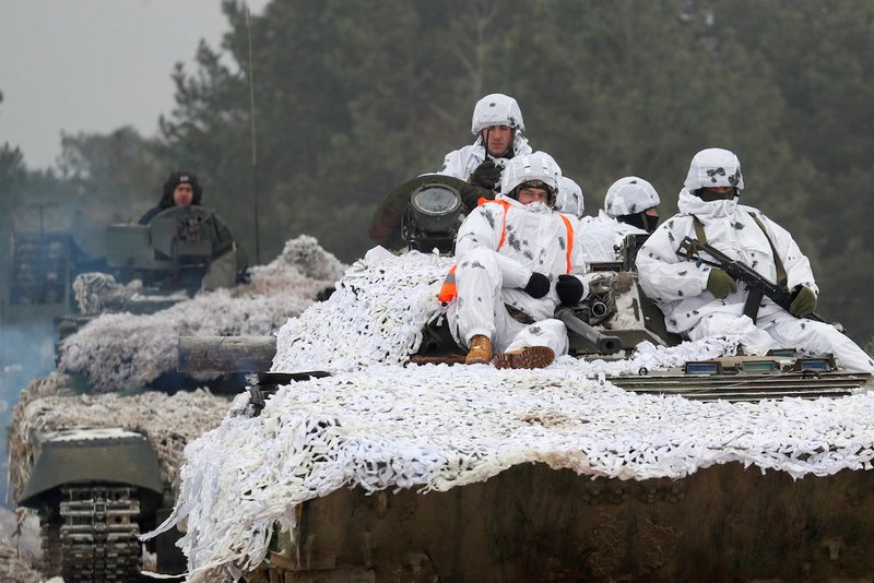 Ukrainian soldiers ride atop armored vehicles during military exercises Dec. 3 in the Ukrainian ground forces training center near Honcharivske. Ukrainian Catholic bishops said Ukrainians had a "right and sacred duty" to defend themselves against "Russian aggression