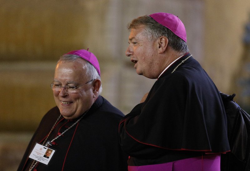 Archbishop Charles J. Chaput of Philadelphia and Archbishop Anthony Fisher of Sydney leave the opening session of the Synod of Bishops on young people