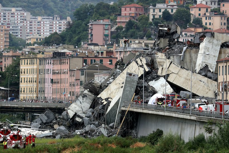 Rescue workers are seen at the collapsed Morandi Bridge in the Italian port city of Genoa in this Aug. 14