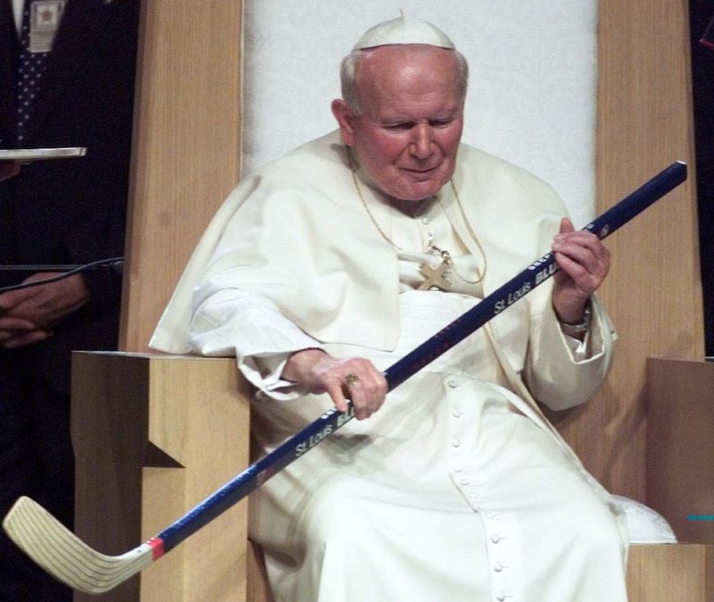 St. John Paul II swings a St. Louis Blues' hockey stick given to him by young people during his visit to the Kiel Center in St. Louis for rally in this Jan. 26