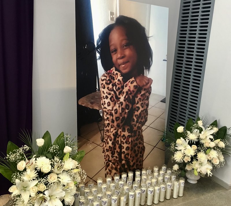 A large photo of Trinity Love Jones in front of 75 lit candles was behind the altar at Saint John Vianney Catholic Church during the Monday funeral. (TOM HOFFARTH)
