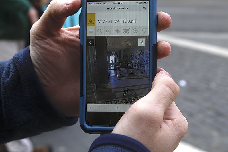 Justin Myers shows what the virtual tours of the Vatican Museums look like on an iPhone Dec. 13. Myers is an intern from Villanova University developing virtual tours of the Vatican Museums. (CNS Photo/Anne Condodina)