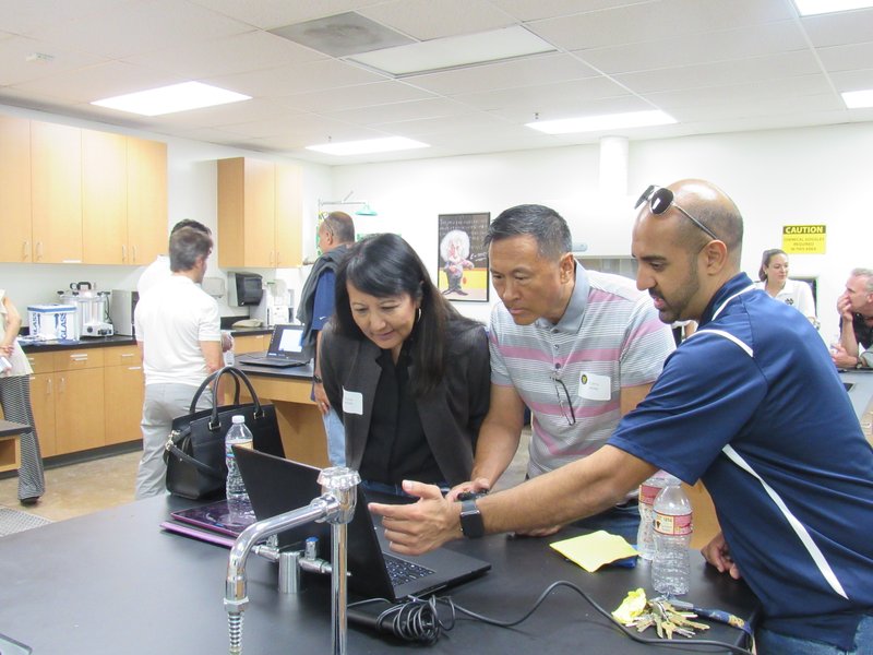 Parents look at MRI and CT data of the human body at a reception held on September 24