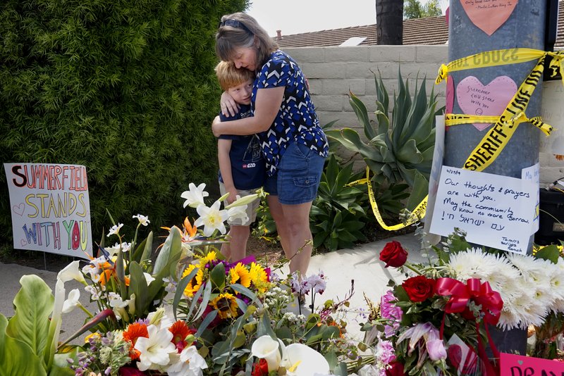 Mourners Heather Foy and her son Marshall