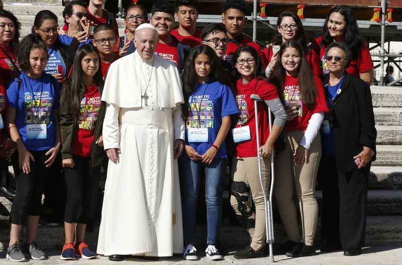 Pope Francis poses with U.S.-born children in families that hold Temporary Protected Status