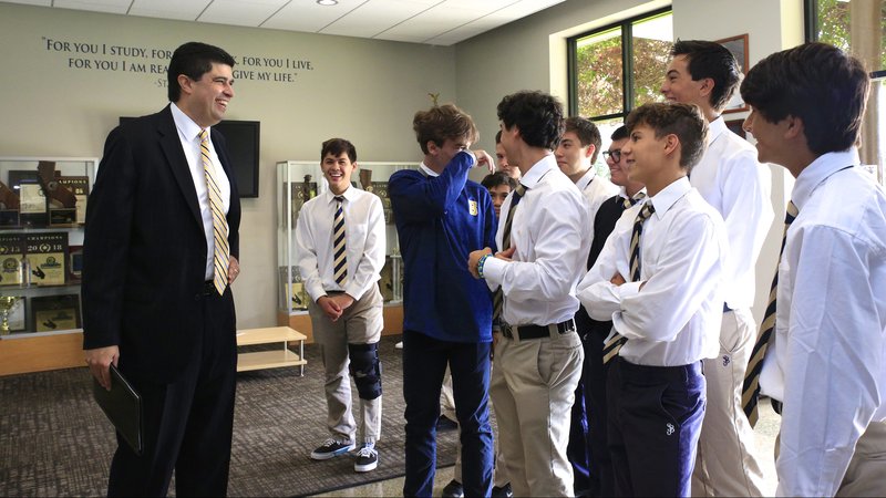 Paul Escala, new senior director and superintendent of schools for the Archdiocese of Los Angeles, talks with St. John Bosco students before Mass on Aug. 15. Many of the students went through St. Joseph's Elementary School in Long Beach, where Escala's two sons are now enrolled. (DAVID AMADOR RIVERA)