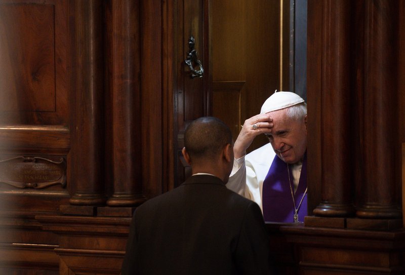 Pope Francis hears the confession of a priest March 7