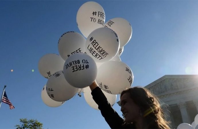 A protester holds balloons calling for religious freedom outside the Supreme Court in 2015. (Image via Crux)