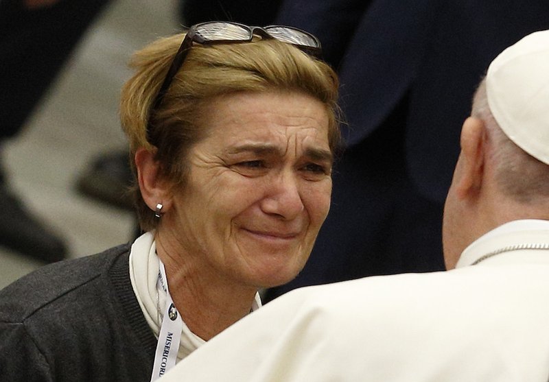 Pope Francis greets a woman before eating lunch with the poor in Paul VI hall at the Vatican Nov. 18. The pope ate lunch with some 1