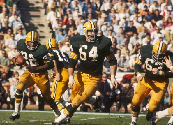 Green Bay Packers guard Jerry Kramer (64) leads the blocking for running back Elijah Pitts (22) during Super Bowl I