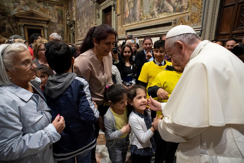 Pope Francis greets children during a meeting with Italy's Roma