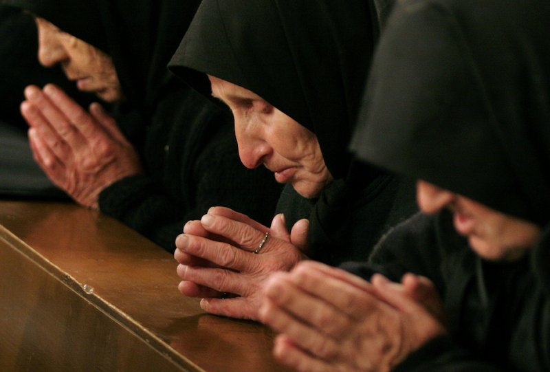 Bulgarian Catholic worshippers pray during Mass at St. Michael the Archangel Cathedral in Rakovski April 8