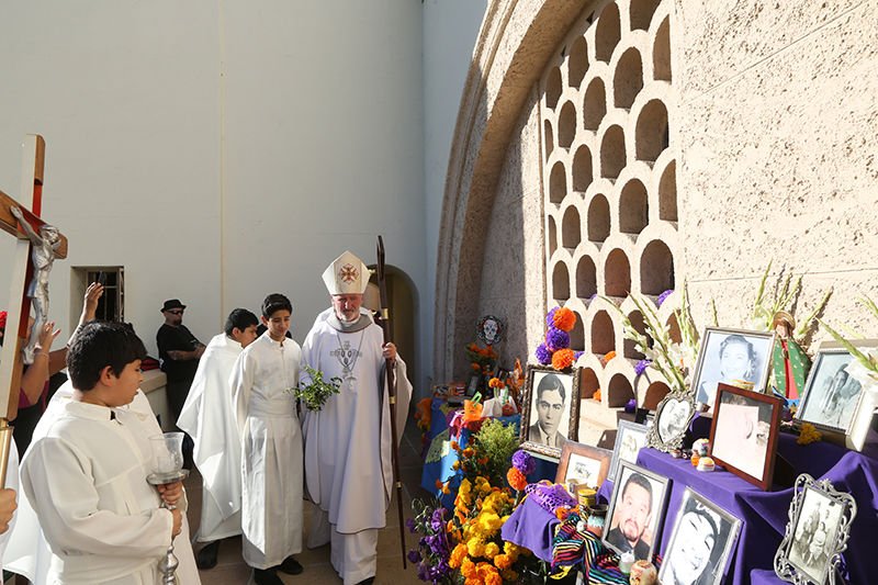 Auxiliary Bishop David G. O’Connell blesses altars during Día de los Muertos celebration at Calvary Cemetery in East Los Angeles Nov. 1