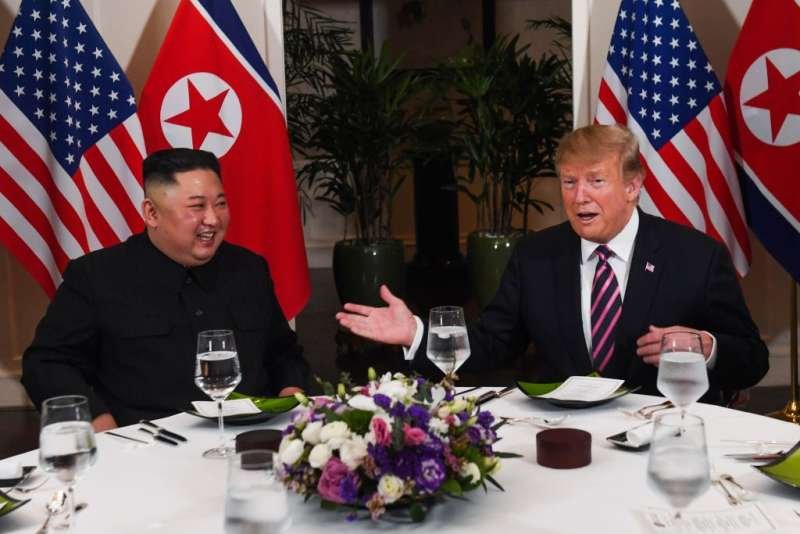 US President Donald Trump (R) and North Korea's leader Kim Jong Un sit for a dinner at the Sofitel Legend Metropole hotel in Hanoi