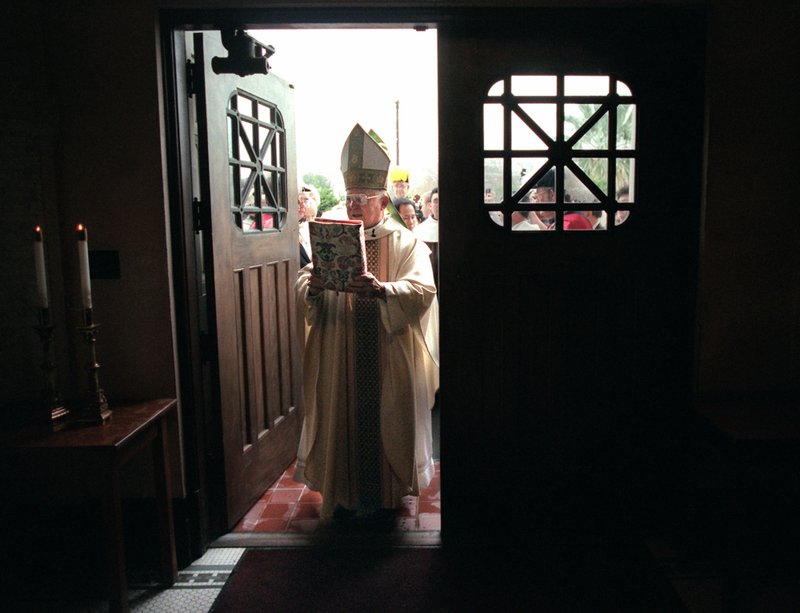 Archbishop Patrick Flores marks the beginning of the new millenium by passing through the holy doors at the Basilica of the National Shrine of the Little Flower January 1