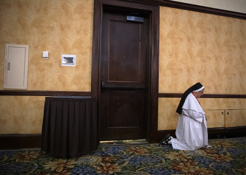 A woman religious prays Sept. 21