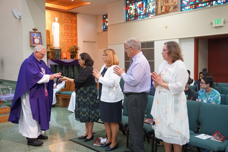 Fr. Alan Jenkins, pastor of St. John the Evangelist parish in South LA, with Lay Mission-Helpers during a special sending Mass. (R.W. DELLINGER)