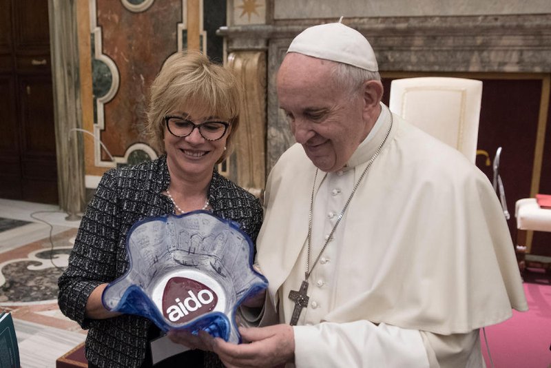 Pope Francis accepts a gift during an audience with members of the Italian Association of Organ Donors at the Vatican April 13