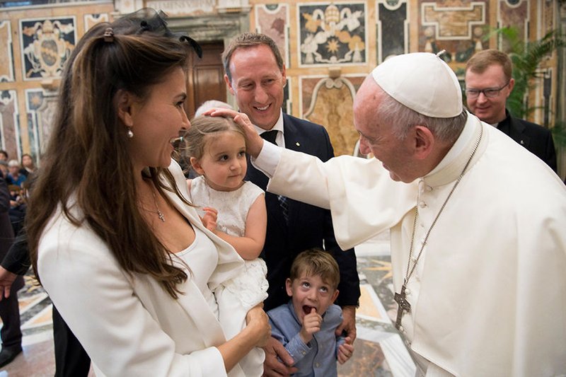 Pope Francis greets family members during an audience with participants in an international congress on protecting children in a digital world